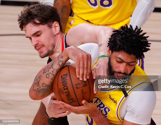 Anthony Davis of the Los Angeles Laker strips the ball from Mario Hezonja of the Portland Trail Blazers during the third quarter in Game Five of the...