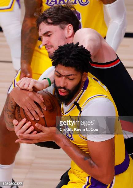 Anthony Davis of the Los Angeles Laker strips the ball from Mario Hezonja of the Portland Trail Blazers during the third quarter in Game Five of the...