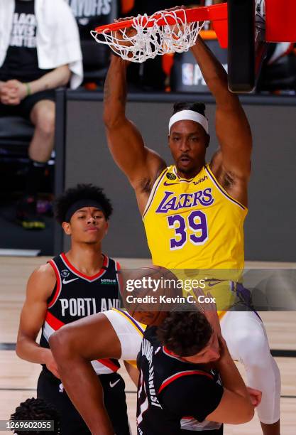 Dwight Howard of the Los Angeles Lakers dunks against Jusuf Nurkic of the Portland Trail Blazers during the fourth quarter in Game Five of the...