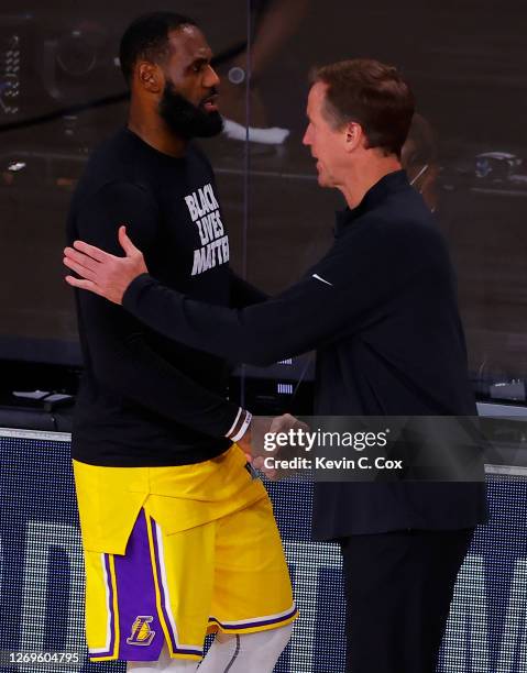 Terry Stotts of the Portland Trail Blazers and LeBron James of the Los Angeles Lakers shake hands following Portland's series loss in Game Five of...