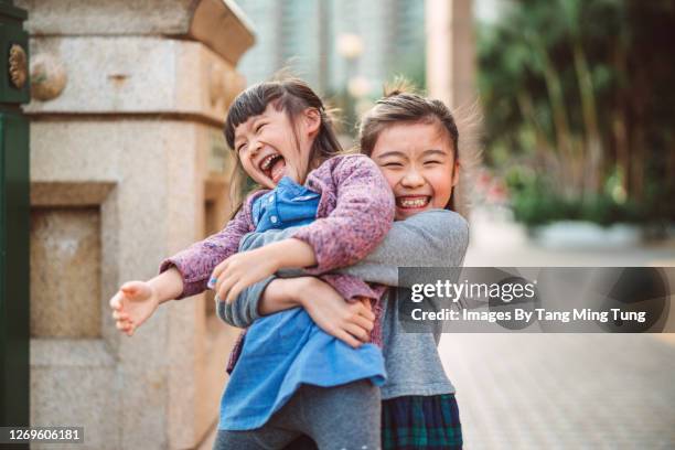 lovely little sibling playing joyfully in promenade - 兄弟姉妹 ストックフォトと画像