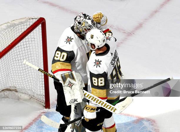 Robin Lehner of the Vegas Golden Knights is congratulated by his teammate, Nate Schmidt, after his 3-0 shutout victory against the Vancouver Canucks...