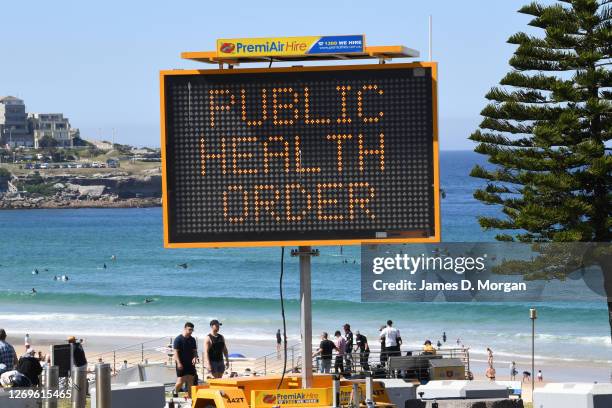 Digital display warning beachgoers regarding Covid-19 at Bondi Beach on August 30, 2020 in Sydney, Australia. Warm winter weather is being enjoyed...