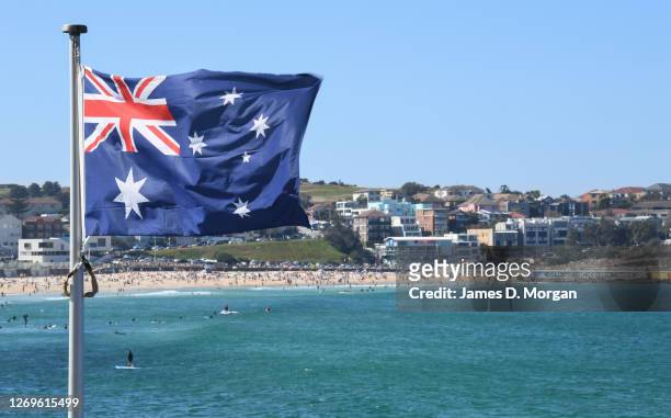 An Australian flag flies at Icebergs pool at Bondi Beach on August 30, 2020 in Sydney, Australia. Warm winter weather is being enjoyed across the...