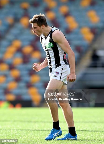 Josh Thomas of the Magpies celebrates kicking a goal during the round 14 AFL match between the Carlton Blues and the Collingwood Magpies at The Gabba...