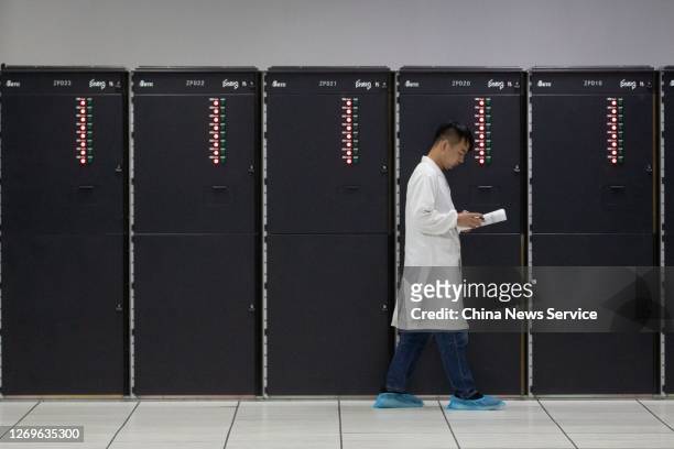 Staff member works beside China's 'Sunway TaihuLight' supercomputer at the National Supercomputer Center on August 29, 2020 in Wuxi, Jiangsu Province...