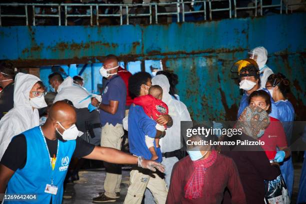 Large fishing ship coming from Libya and just arrived in port in the night escorted by the Italian Coast Guard, is about to disembark 450 migrants...