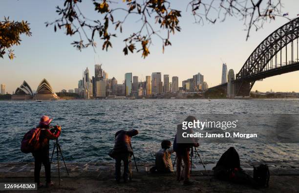 Photographic enthusiasts take photos of the sunset in the suburb of Kiribilli on August 30, 2020 in Sydney, Australia. Warm winter weather is being...