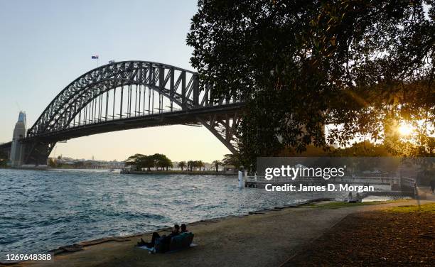 Man and woman sit on a sofa to enjoy the sunset in the suburb of Kiribilli on August 30, 2020 in Sydney, Australia. Warm winter weather is being...