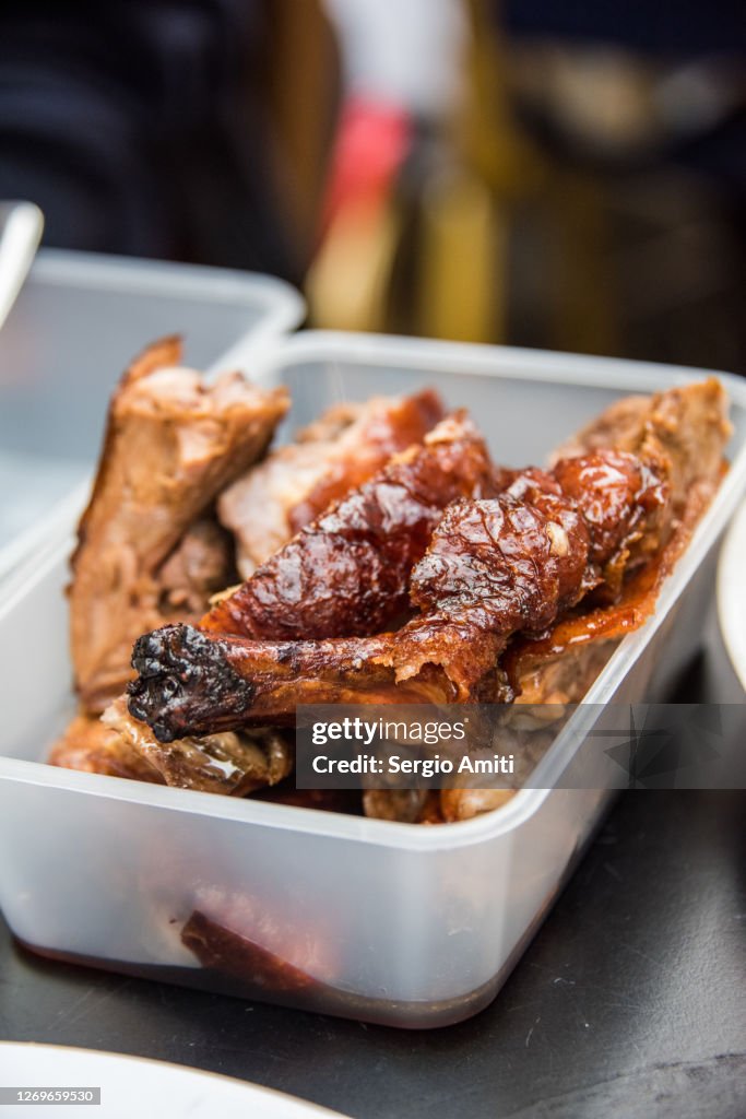 Chinese roast duck in a takeout container