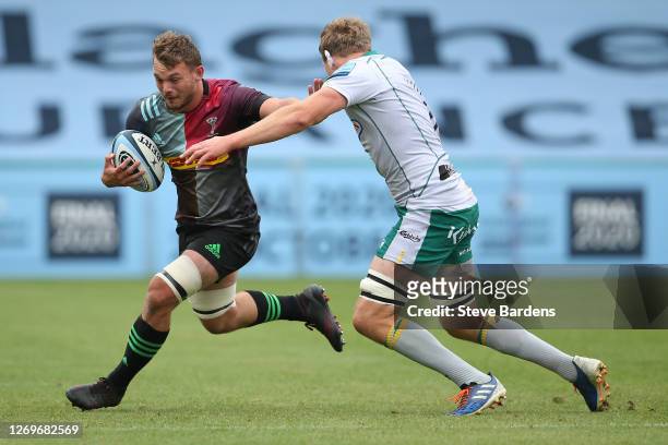 Will Evans of Harlequins hands off Jamie Gibson of Northampton Saints during the Gallagher Premiership Rugby match between Harlequins and Northampton...