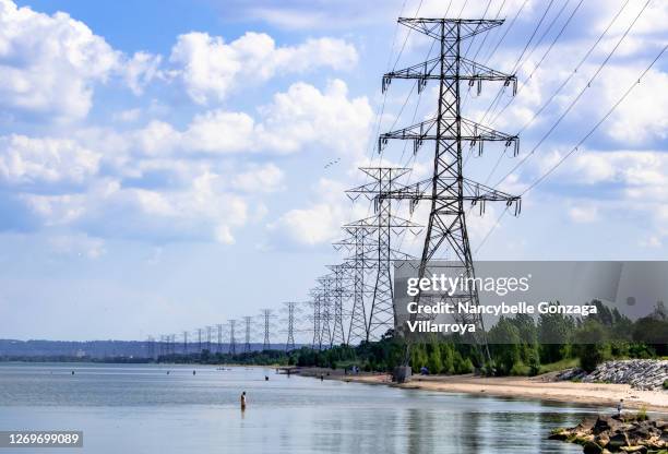 high voltage power lines along lake ontario - ontario canada landscape stock pictures, royalty-free photos & images