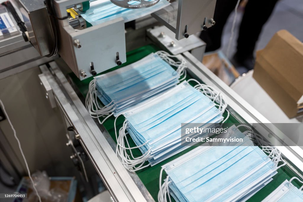 Close-up of producing protective face mask in production line