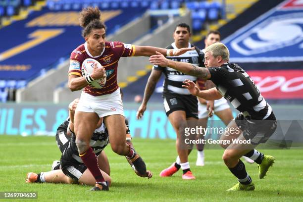 Jamie Shaul of Hull FC attempts to tackle Ashton Golding of Huddersfield Giants during the Betfred Super League match between Huddersfield Giants and...