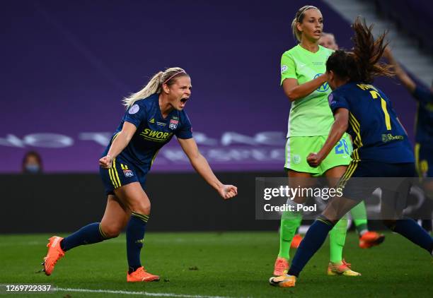 Eugenie Le Sommer of Olympique Lyon celebrates with teammate Amel Majri after scoring her team's first goal during the UEFA Women's Champions League...