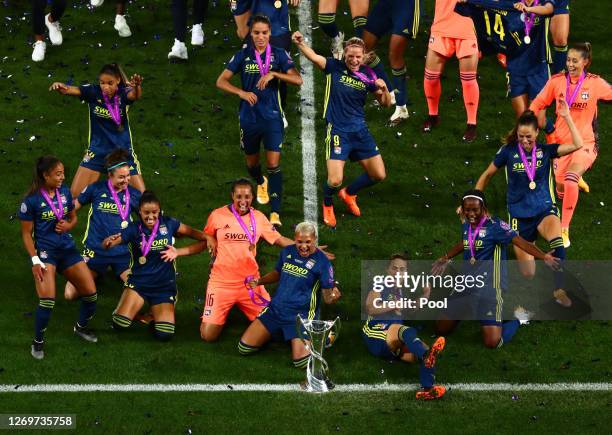 Olympique Lyon players celebrate with the UEFA Women's Champions League Trophy following their team's victory in the UEFA Women's Champions League...