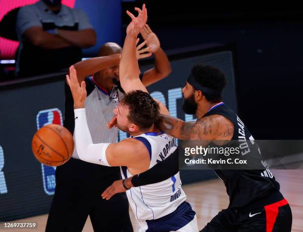 Marcus Morris Sr. #31 of the LA Clippers fouls Luka Doncic of the Dallas Mavericks during the first quarter in Game Six of the Western Conference...