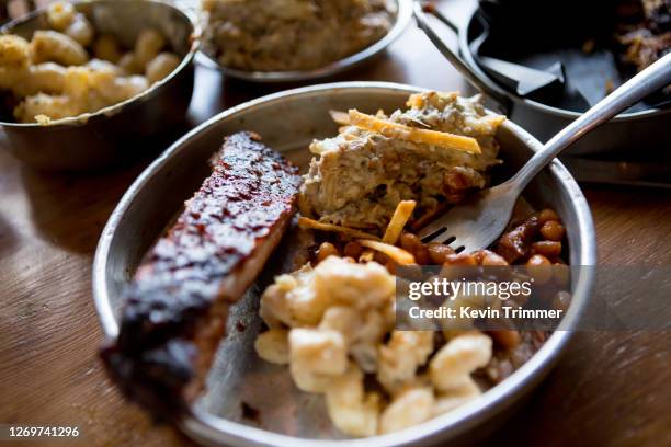 variety of barbecue food with side dishes on table - comfort food fotografías e imágenes de stock