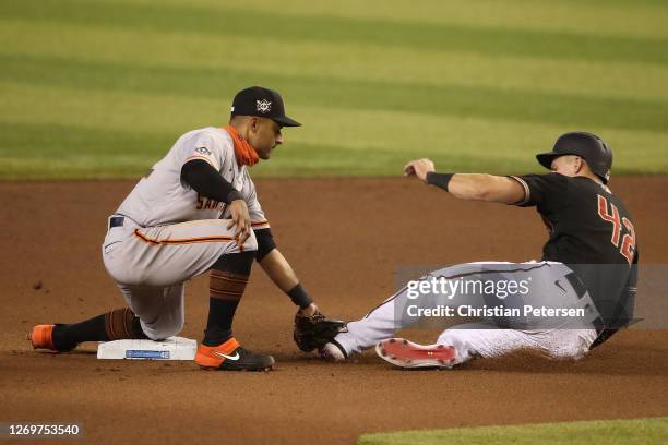 Infielder Donovan Solano of the San Francisco Giants tags out Jake Lamb of the Arizona Diamondbacks as he attempts to steal second base during the...