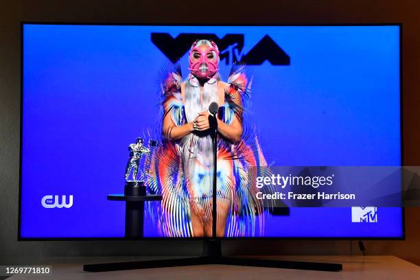 In this photo illustration, Lady Gaga accepts the Best Collaboration award for "Rain on Me" with Ariana Grande, viewed on a television screen, during...