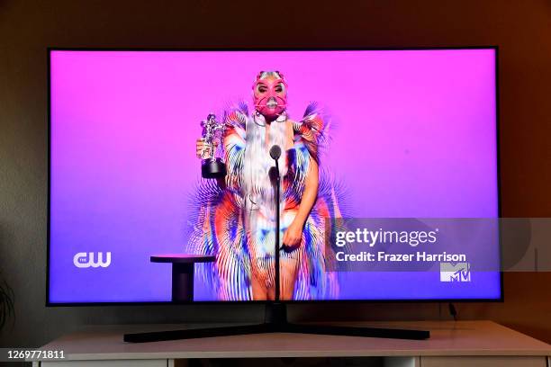 In this photo illustration, Lady Gaga accepts the Best Collaboration award for "Rain on Me" with Ariana Grande, viewed on a television screen, during...