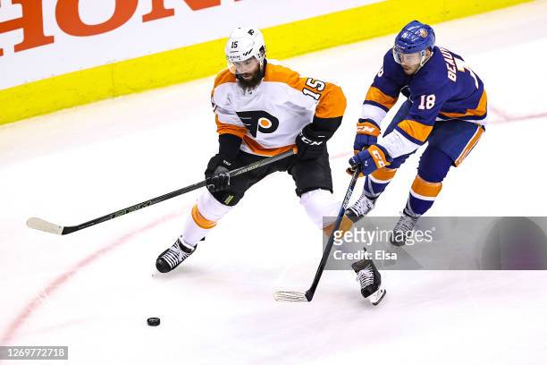 Matt Niskanen of the Philadelphia Flyers is defended by Anthony Beauvillier of the New York Islanders during the second period in Game Four of the...