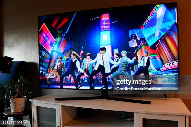 In this photo illustration, BTS, viewed on a television screen, perform during the 2020 MTV Video Music Awards broadcast on August 30, 2020.