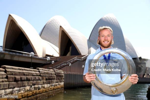 Rhyan Grant poses with the A-League Trophy during an A-League media opportunity after Sydney FC won last night's Grand Final, at Sydney Opera House...