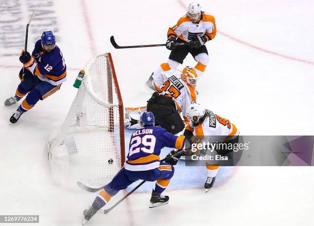 Brock Nelson of the New York Islanders scores a goal assisted by Josh Bailey past Brian Elliott of the Philadelphia Flyers during the third period in...