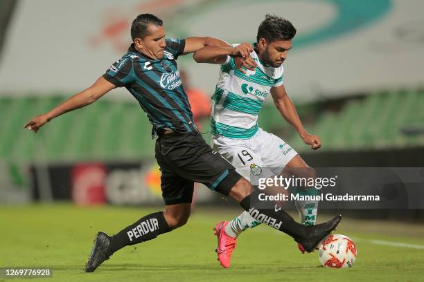 Alfonso Luna of Queretaro fights for the ball wtih Eduardo Aguirre of Santos during the 7th round match between Santos Laguna and Queretaro as part...