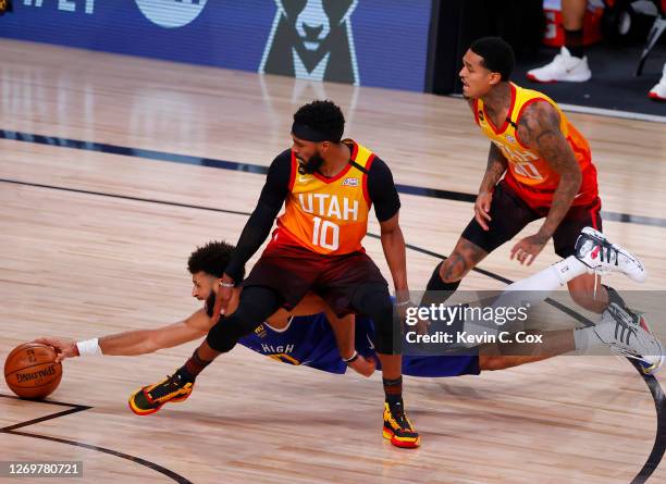 Jamal Murray of the Denver Nuggets dives to grab a loose ball against Mike Conley and Jordan Clarkson of the Utah Jazz during the fourth quarter in...