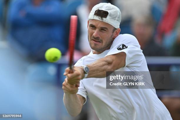 Player Tommy Paul returns to US player Jeffrey John Wolf during their men's singles quarter-final tennis match at the Rothesay Eastbourne...