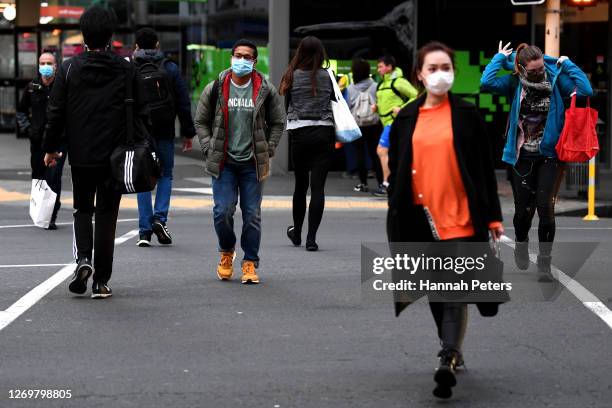 Members of the public wear face masks on August 31, 2020 in Auckland, New Zealand. Face coverings are now compulsory for all New Zealanders over the...