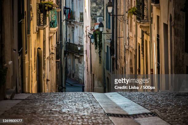 view of alley amidst buildings in city, montpellier, france - montpellier stock pictures, royalty-free photos & images