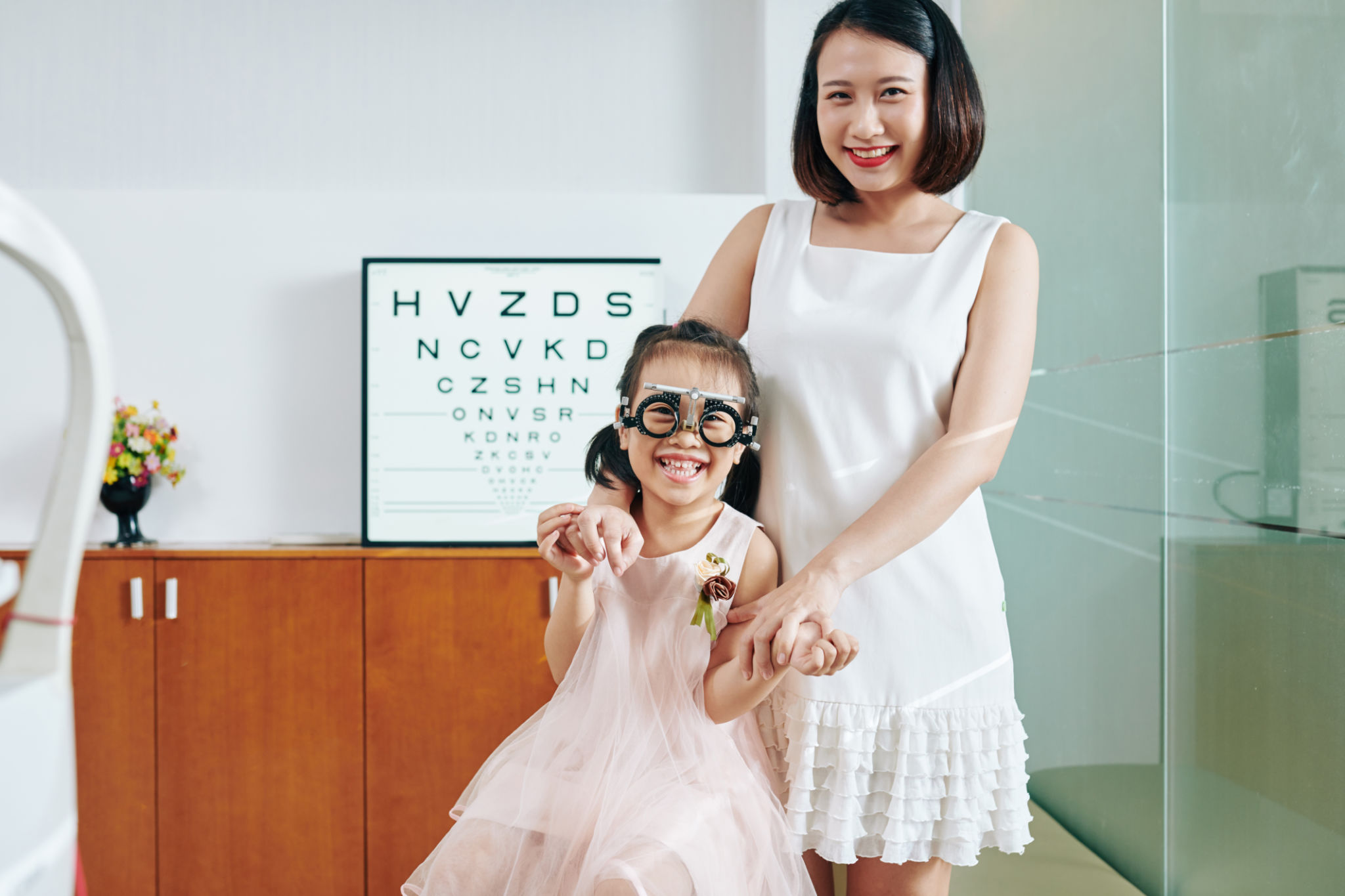 Mother and daughter visiting ophthalmologist Mother and daughter visiting ophthalmologist