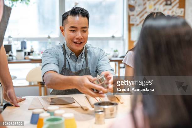 hong kong businessman participating in art therapy class - art therapy stock pictures, royalty-free photos & images