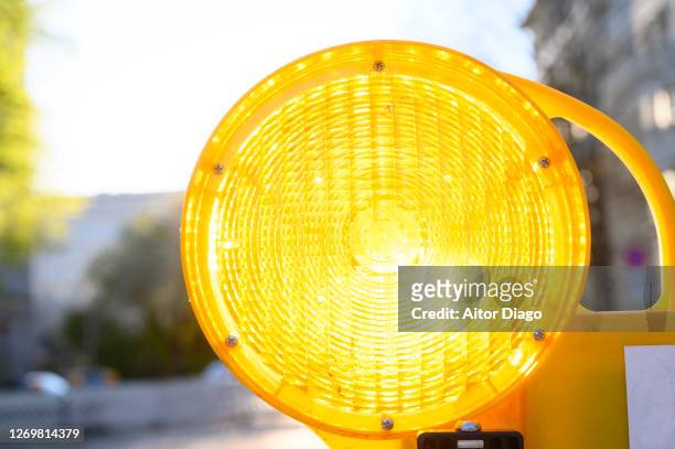 close up of orange light signal warning of road works. germany. - yellow light stock pictures, royalty-free photos & images