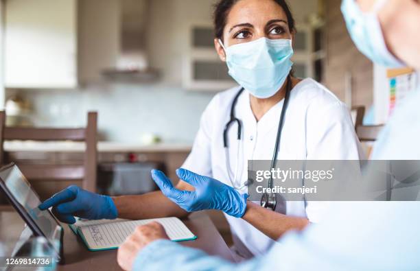 nurse visiting a senior patient at home - global healthcare stock pictures, royalty-free photos & images