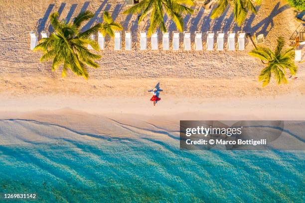 woman relaxing on idyllic beach - caribbean culture fotografías e imágenes de stock