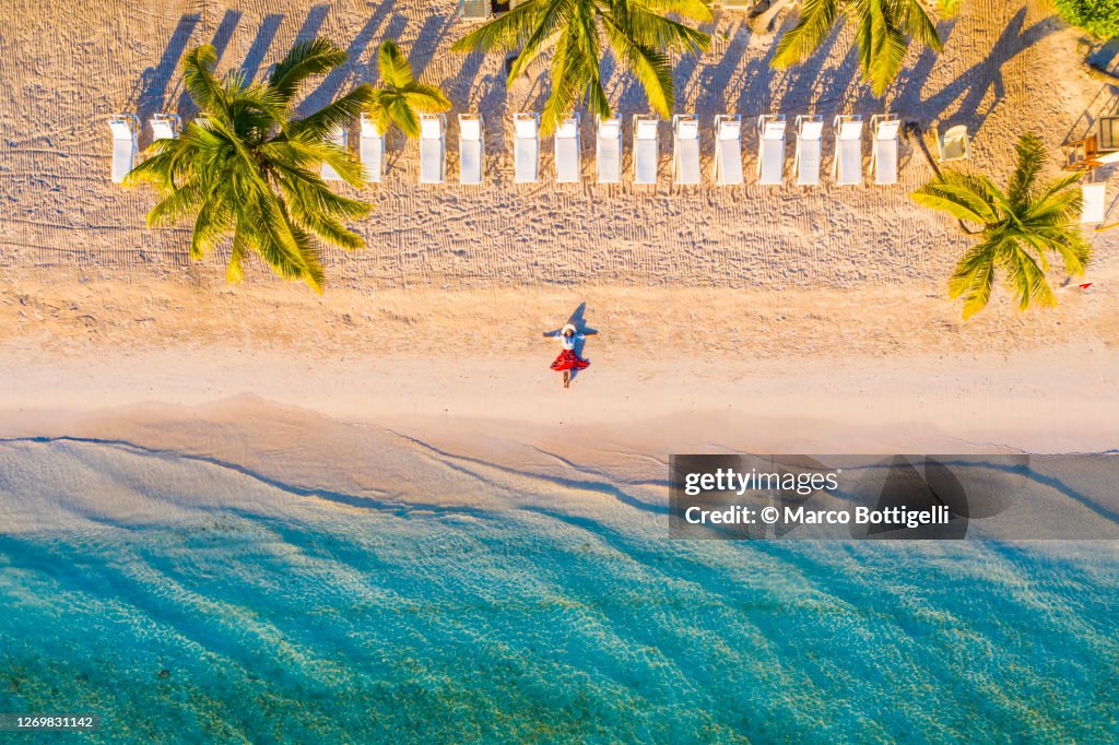 Woman relaxing on idyllic beach