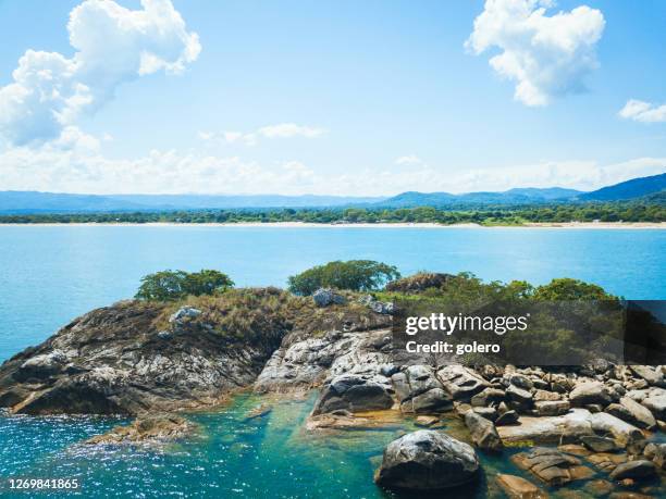 lake malawi with tiny island in foreground - malawi stock pictures, royalty-free photos & images