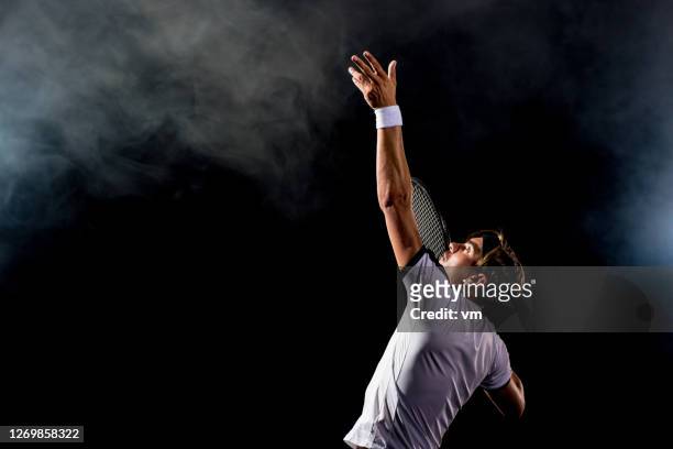 tennis player serving the ball - tennis player stock pictures, royalty-free photos & images