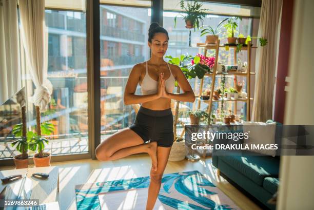 young sporty woman practicing yoga - bikram yoga stock pictures, royalty-free photos & images