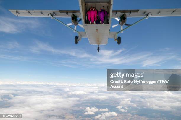 wingsuit fliers leave airplane rear, in mid-air - gorizia stock pictures, royalty-free photos & images