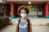 Girl on school campus with mask for COVID-19