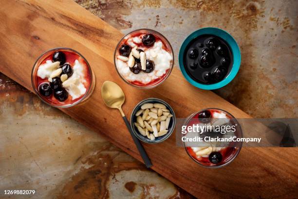 traditional risalamande or rice pudding with almonds and cherry sauce. - christmas denmark stock pictures, royalty-free photos & images