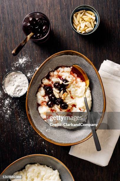 traditional risalamande or rice pudding with almonds and cherry sauce and vanilla sugar - christmas denmark stock pictures, royalty-free photos & images