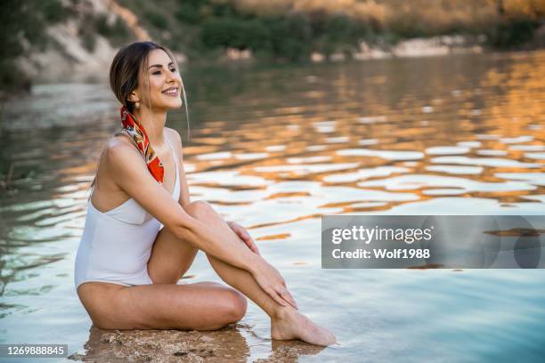 happy woman having fun on lake - woman rubber ring stock pictures, royalty-free photos & images