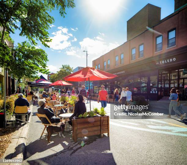 people enjoying the sidewalk cafes in the pedestrian montreal's mont-royal avenue - pedestrian area stock pictures, royalty-free photos & images