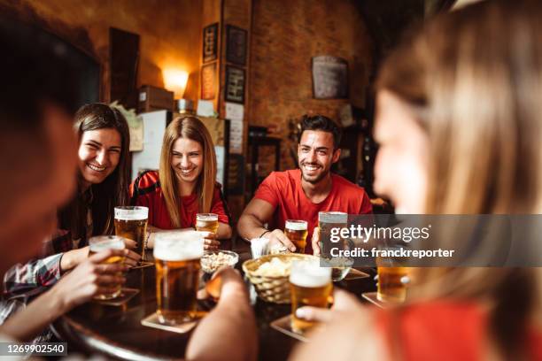 women people talking indoors in a pub with the beers - italy beer stock pictures, royalty-free photos & images